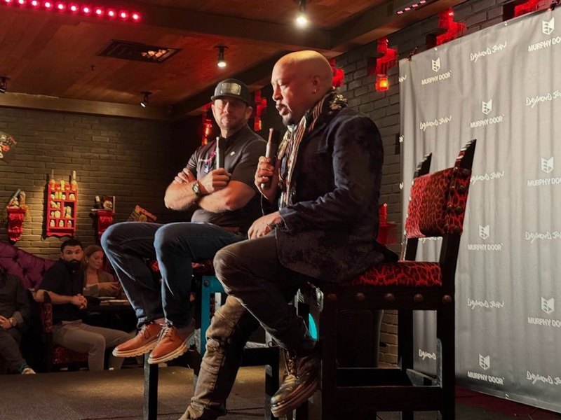 Jeremy Barker on stage with Daymond John, fireside conversation