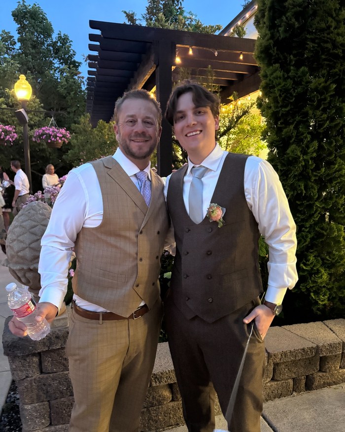 Jeremy and his son Haden in matching vests at a wedding