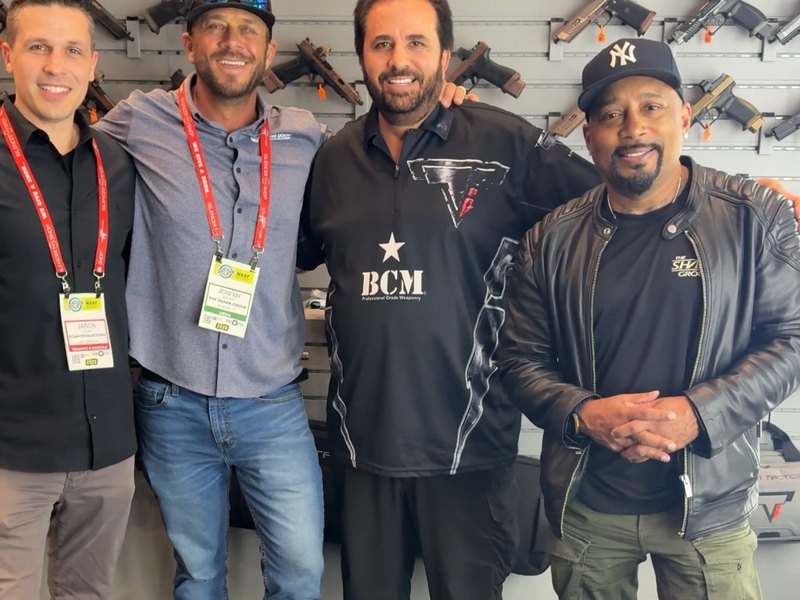 Jeremy Barker with Taran Butler and Daymond John at the Taran Tactical booth at SHOT Show