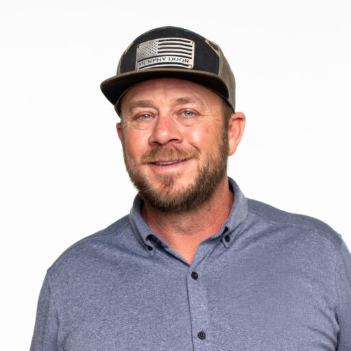 Jeremy Barker wearing a hat and blue shirt headshot
